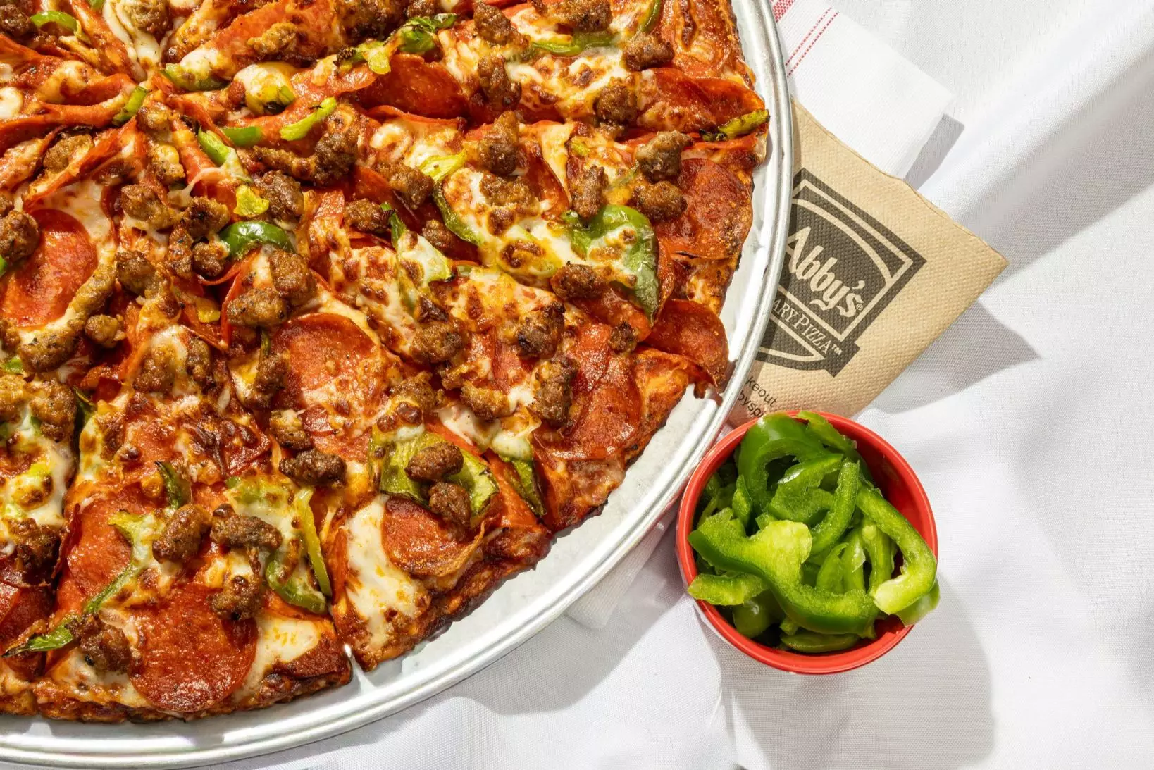 Fresh pizza with generous toppings and real cheese pulled to the edge